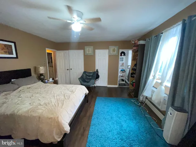 a bed sitting in a bedroom next to a window