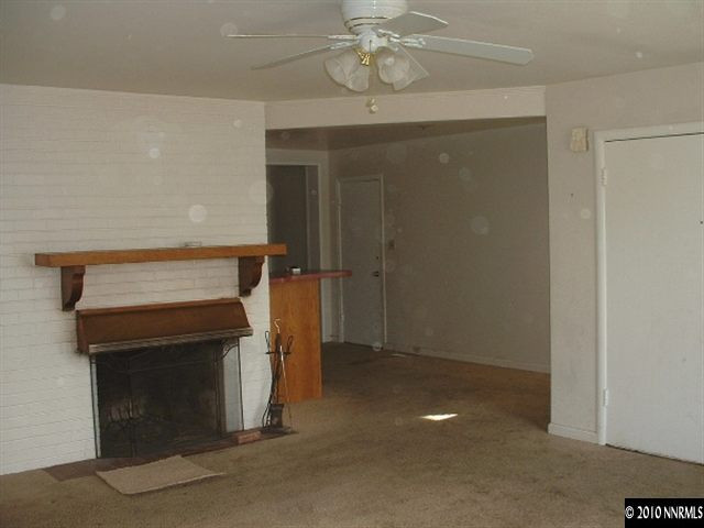 225 Hillcrest Drive Reno, NV 89509 - Photo 2 of 7 a view of empty room with a fireplace and chandelier