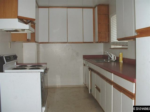 225 Hillcrest Drive Reno, NV 89509 - Photo 4 of 7 a kitchen with stainless steel appliances granite countertop a sink stove and cabinets