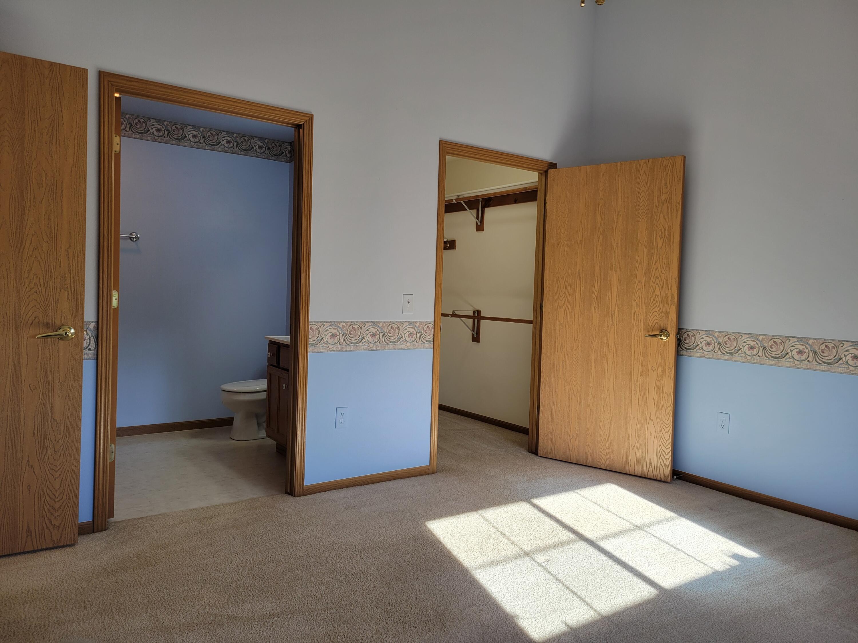 2111 Pine Ridge Court, Unit E Grafton, WI 53024 - Photo 14 of 35 Primary view to closet & bath