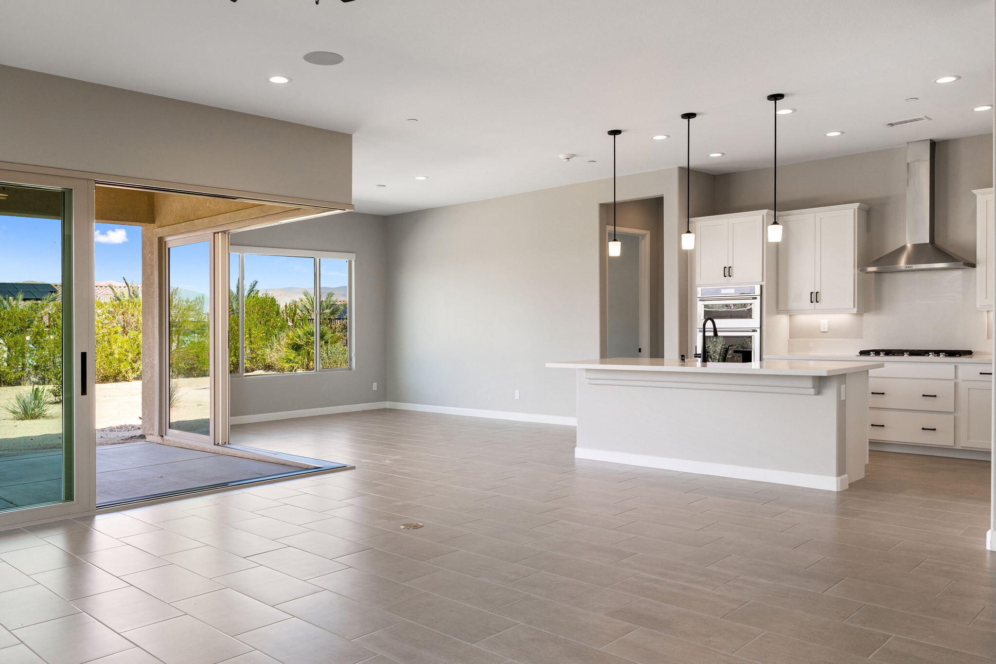 60 Prosecco Rancho Mirage, CA 92270 - Photo 19 of 48 a large white kitchen with stainless steel appliances kitchen island granite countertop a refrigerator and a stove top oven