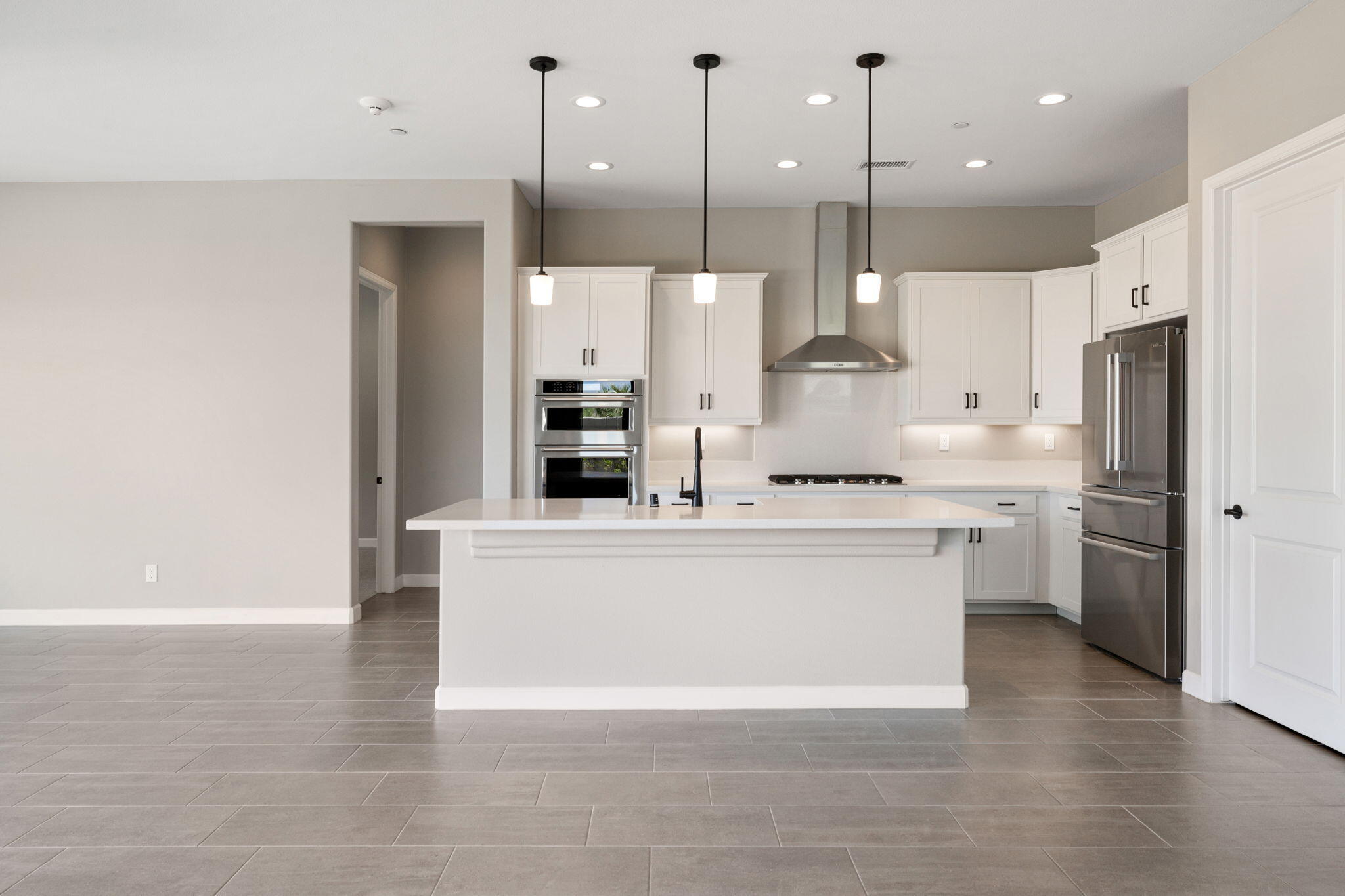 60 Prosecco Rancho Mirage, CA 92270 - Photo 21 of 48 a kitchen with stainless steel appliances granite countertop a sink a stove and a refrigerator