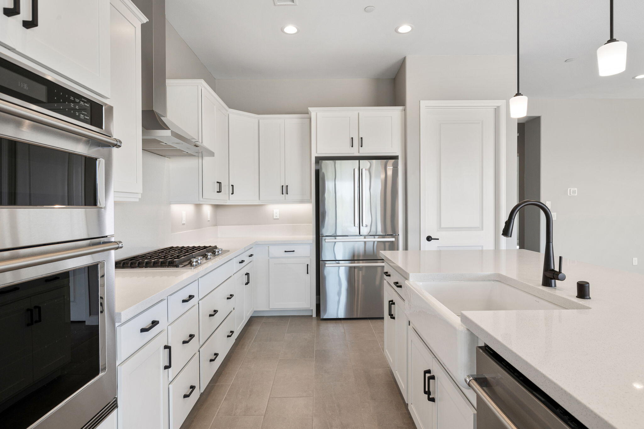 60 Prosecco Rancho Mirage, CA 92270 - Photo 28 of 48 a kitchen with stainless steel appliances granite countertop a stove a sink and a refrigerator