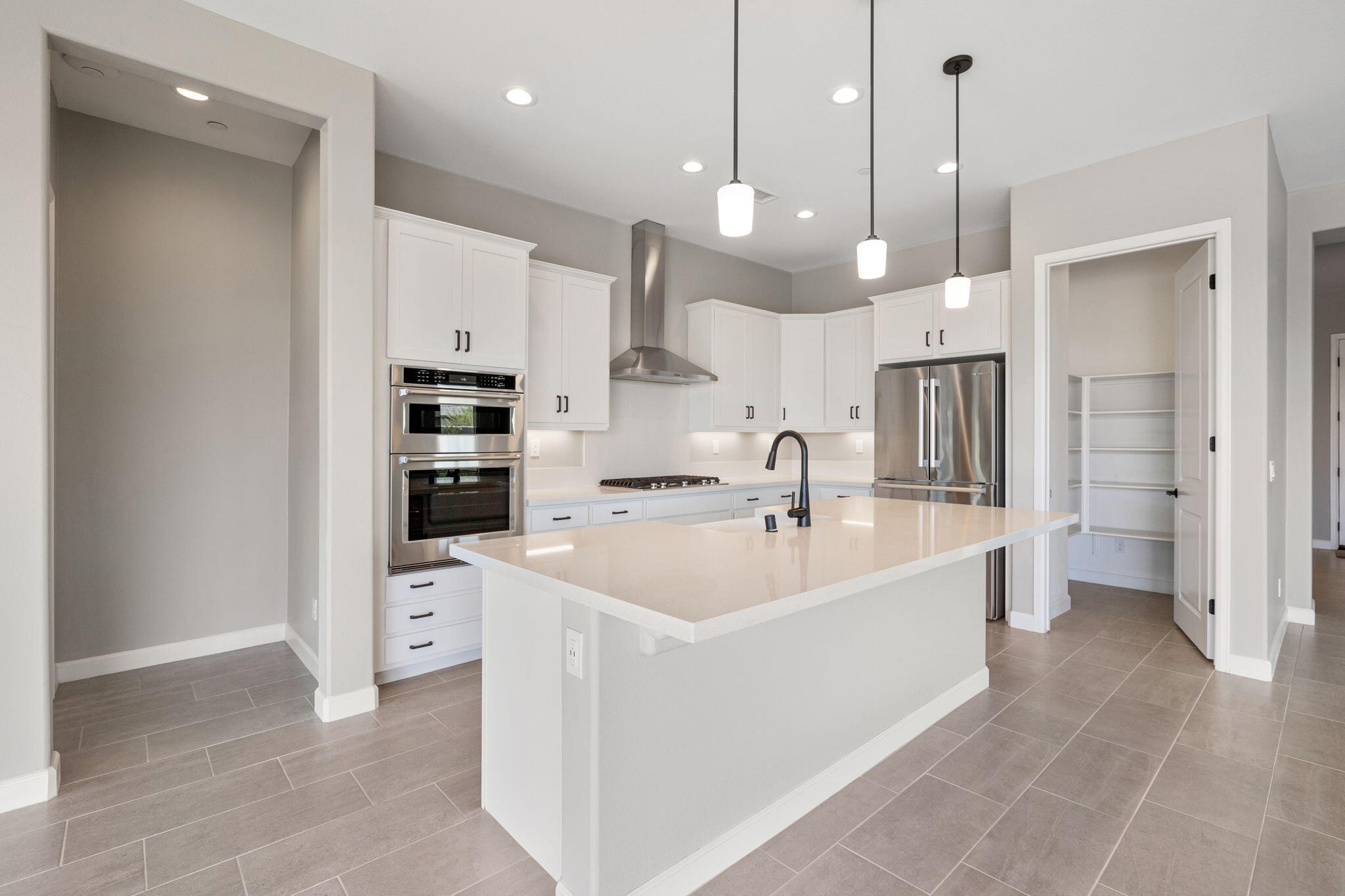 60 Prosecco Rancho Mirage, CA 92270 - Photo 33 of 48 a large white kitchen with a sink a counter space and stainless steel appliances