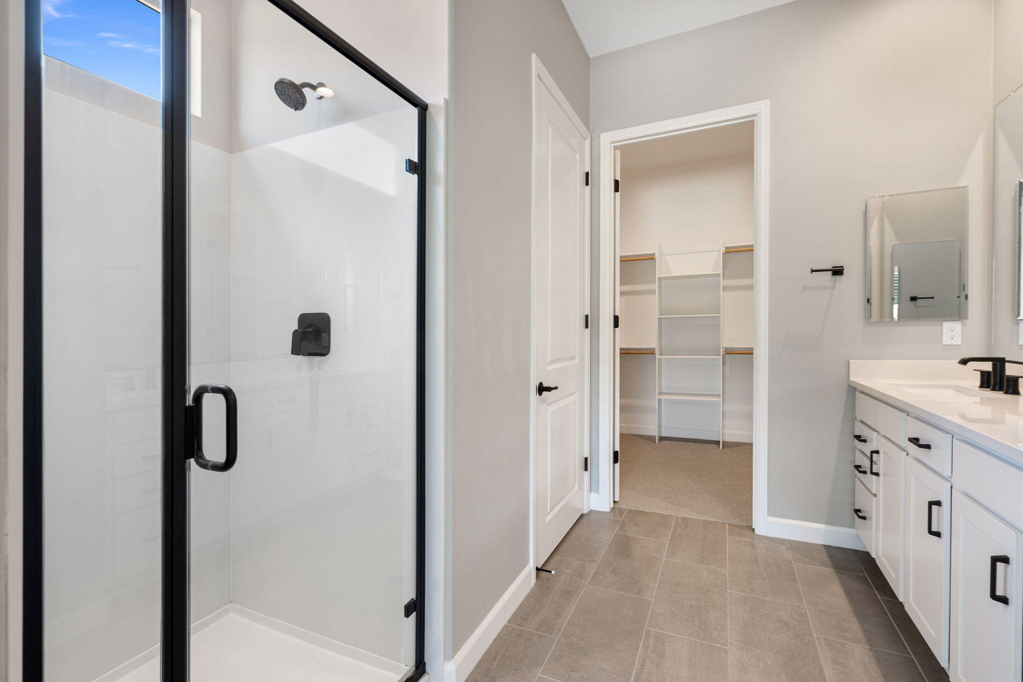 60 Prosecco Rancho Mirage, CA 92270 - Photo 39 of 48 a bathroom with a granite countertop shower mirror and a sink