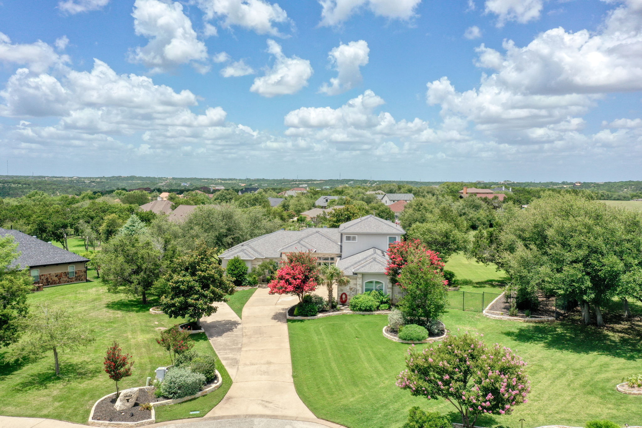 1601 Coronado Leander, TX 78641 - Photo 1 of 37 a view of a garden with a building in the background