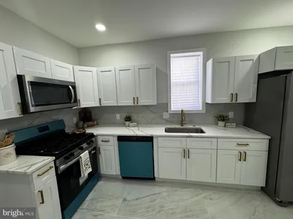 a kitchen with a sink stove and microwave