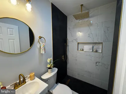 a bathroom with a sink mirror and toilet