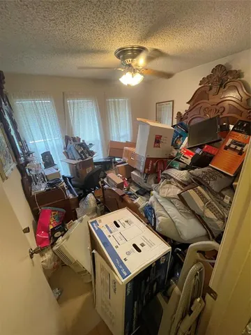 a storage room with washer and lots of different colored cloths