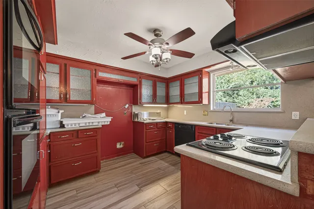 a kitchen with stainless steel appliances granite countertop a stove and a sink