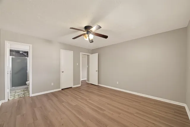 a view of room with hardwood floor and ceiling fan