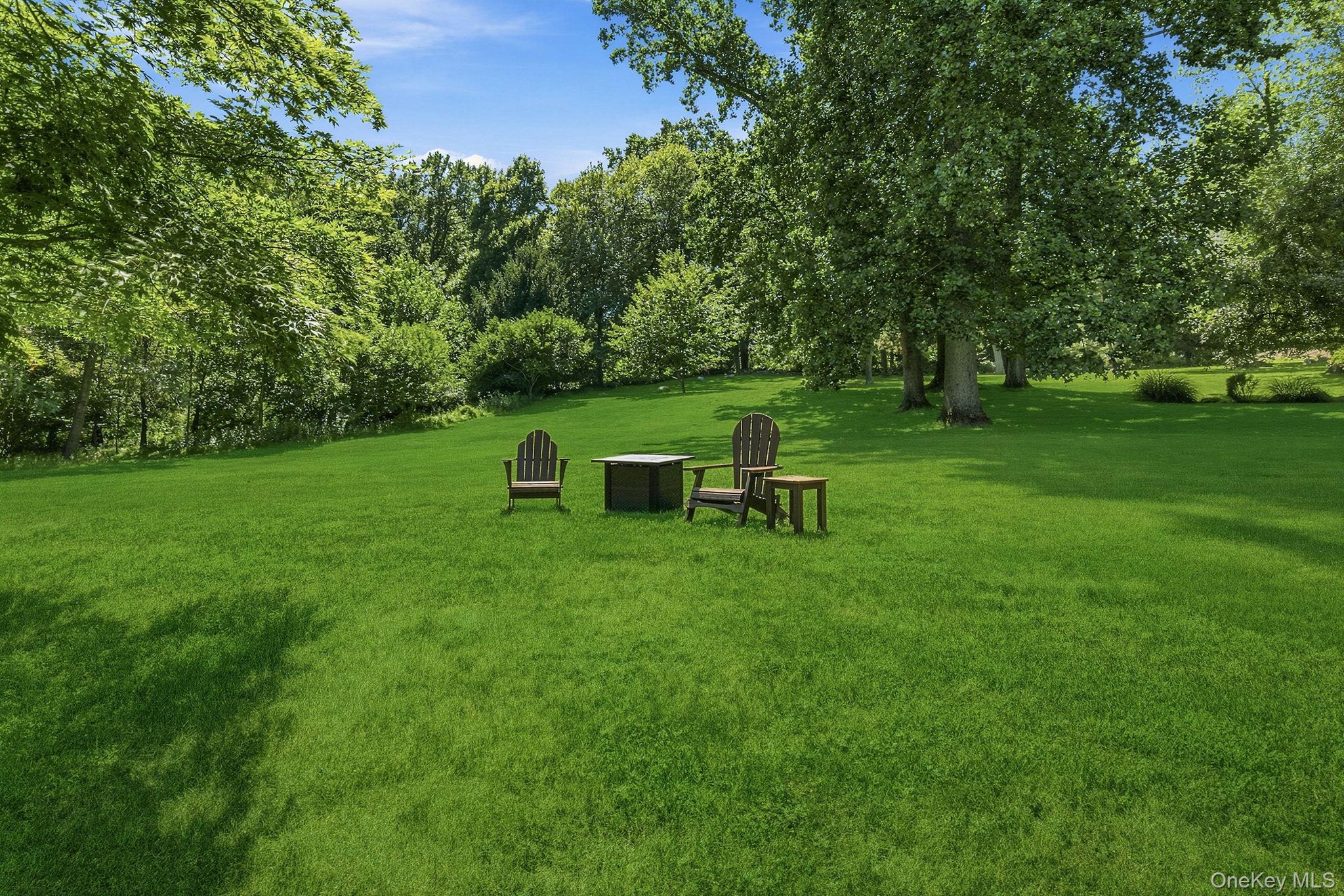 32 Bedell Road Katonah, NY 10536 - Photo 35 of 49 Level, open lawn spreads beneath mature shade trees.