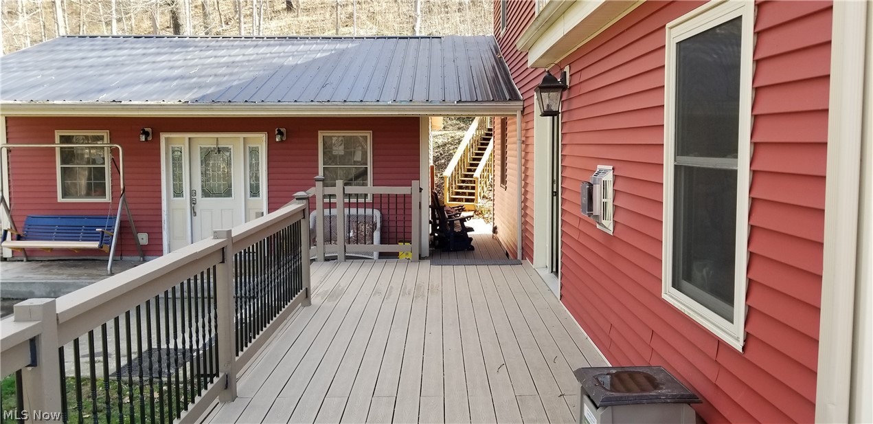 4274 Newbury Road Little Hocking, OH 45742 - Photo 27 of 35 Wrap around deck to the front of the home....thru the breezeway to the garage and up the stairs which lead to the road which will also take you back out to Route 50....There are 2 ways to enter the property from the highway