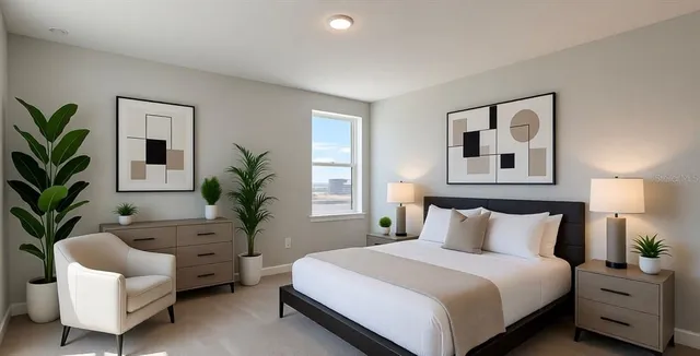 a bedroom with a large bed and a potted plant