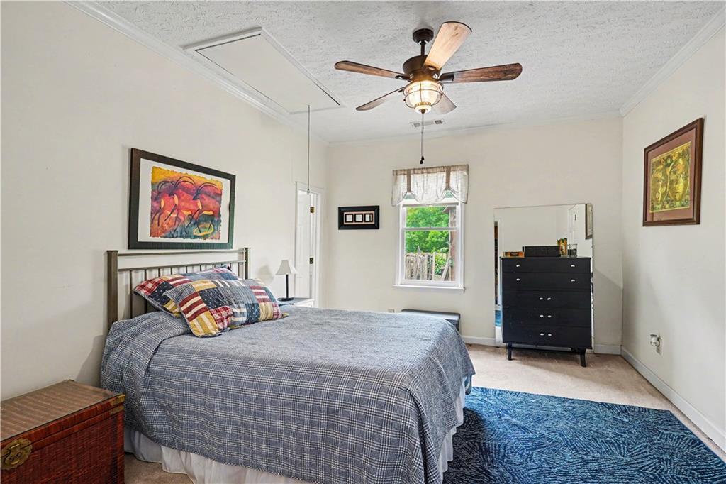355 Inman Road Hampton, GA 30228 - Photo 27 of 47 a bedroom with a bed and a chandelier
