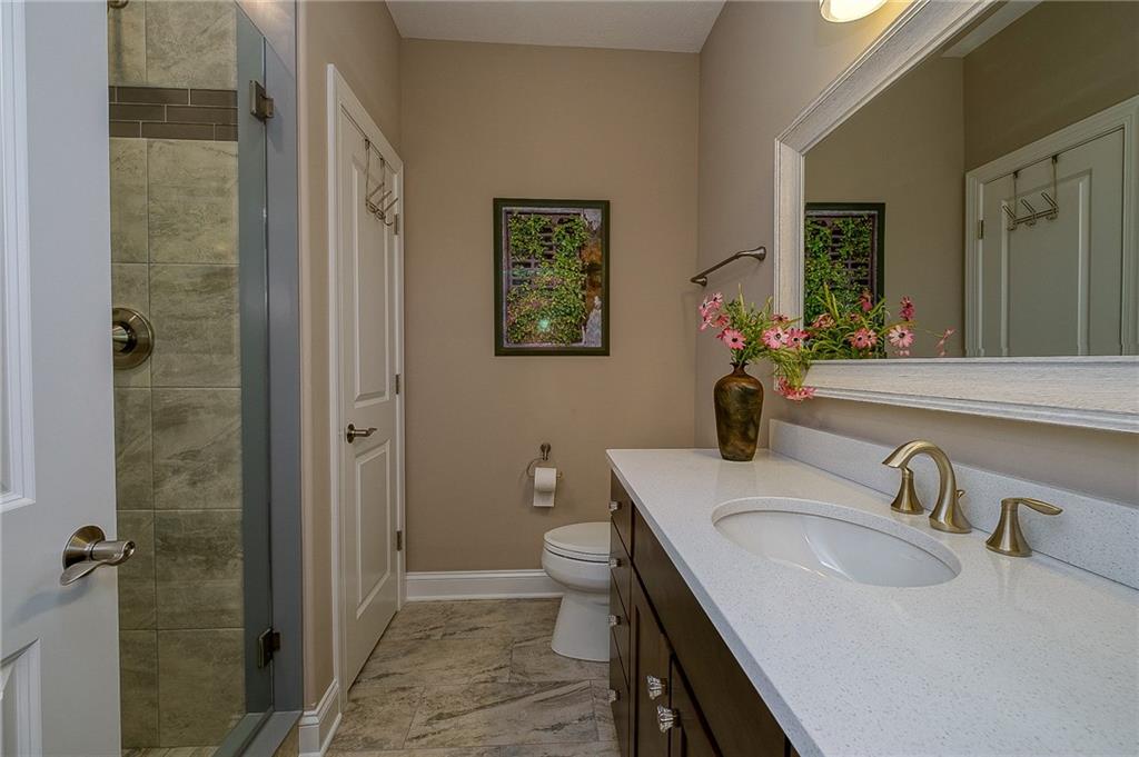 116 Seneca Place Mars, PA 16046 - Photo 17 of 25 a bathroom with a granite countertop sink a toilet and a mirror