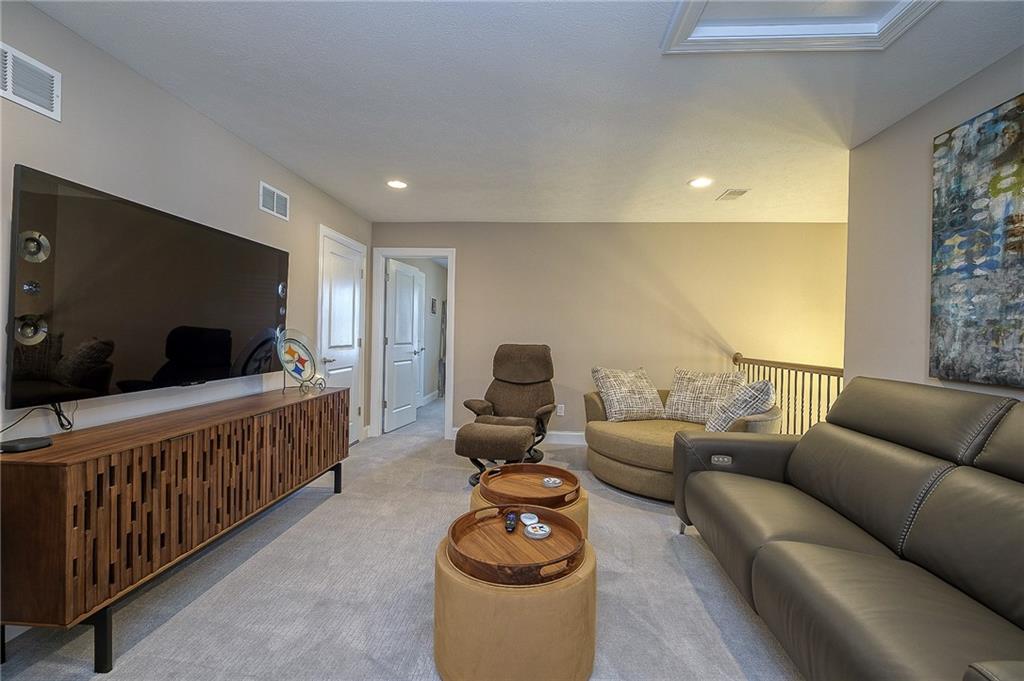 116 Seneca Place Mars, PA 16046 - Photo 20 of 25 a living room with furniture a flat screen tv and a couch