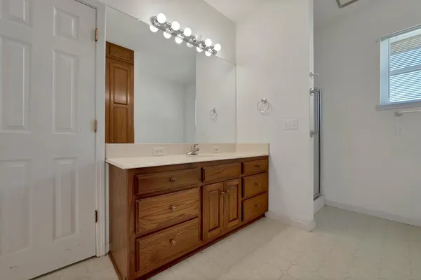 a bathroom with a double vanity sink and a mirror