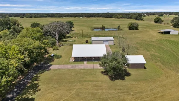an aerial view of a house with a lake view