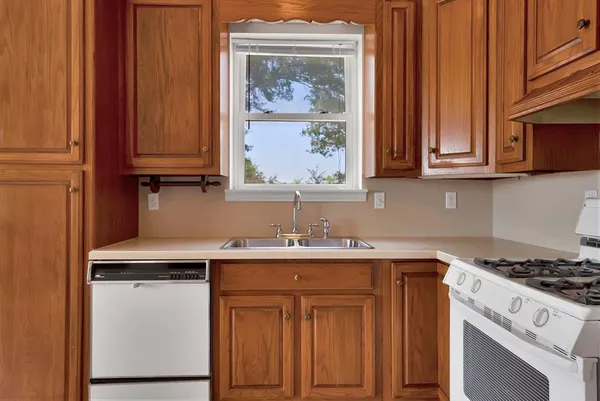 a kitchen with stainless steel appliances granite countertop a sink stove and cabinets