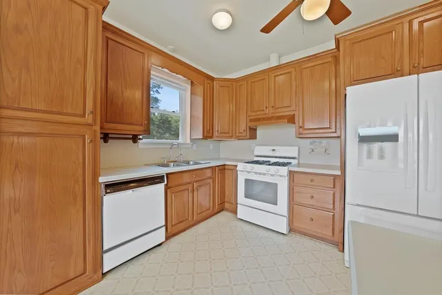 a kitchen with granite countertop a sink stainless steel appliances and cabinets