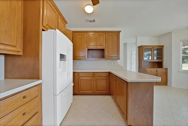 a kitchen with granite countertop a sink and cabinets