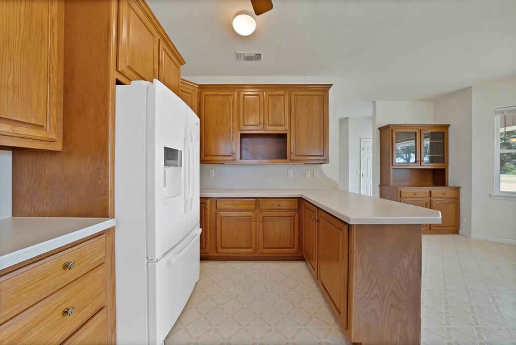 12748 County Road 4077 Scurry, TX 75158 - Photo 24 of 40 a kitchen with granite countertop a sink and cabinets