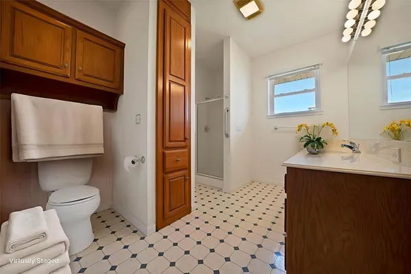a bathroom with a sink toilet and mirror
