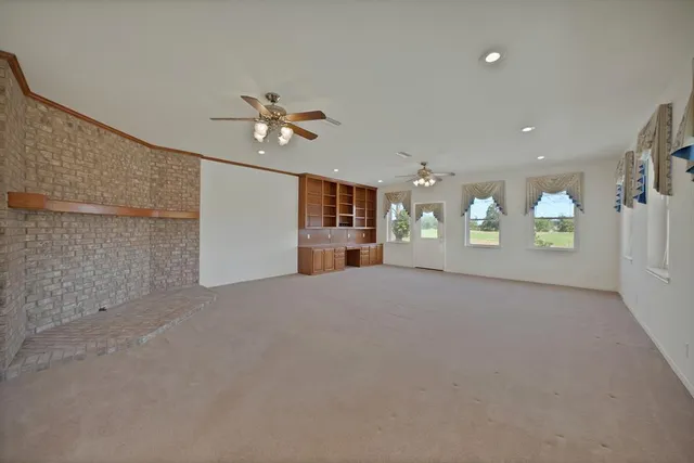 an empty room with a empty space and windows