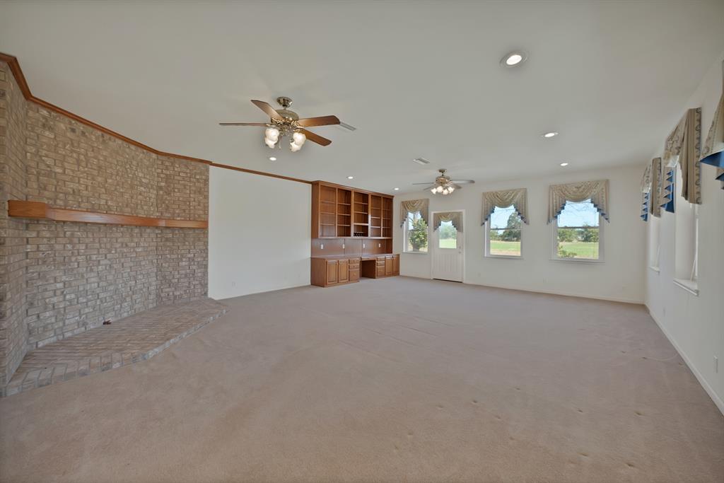 12748 County Road 4077 Scurry, TX 75158 - Photo 3 of 40 an empty room with a empty space and windows
