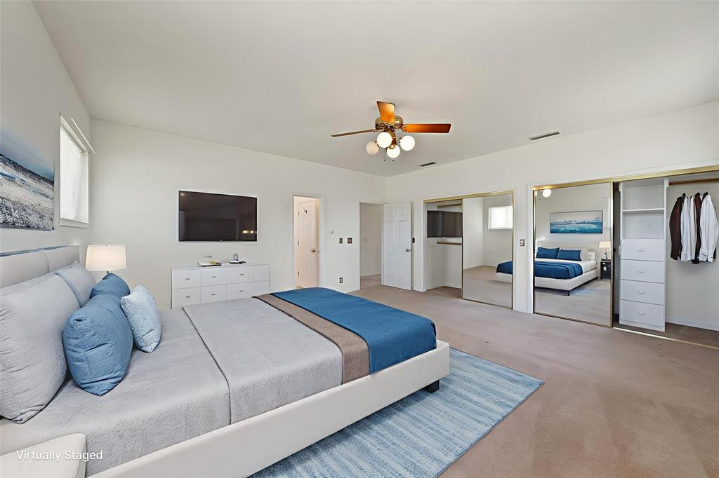 12748 County Road 4077 Scurry, TX 75158 - Photo 4 of 40 a spacious bedroom with a bed and a flat screen tv