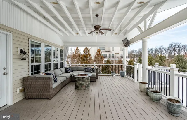 a balcony with furniture and wooden floor