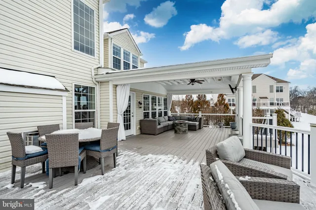 a view of a patio with dining table and chairs with wooden floor