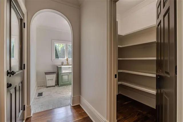 a bathroom with a granite countertop double vanity sink and a mirror