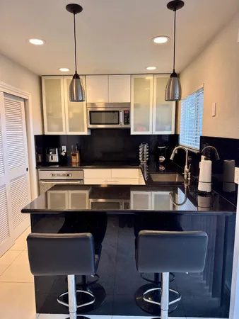 a kitchen with a sink cabinets and window