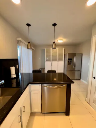 a kitchen with a sink and appliances
