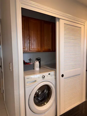 a view of a storage and utility room with washer and dryer