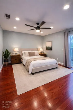 a bedroom with a large bed and a wooden floor