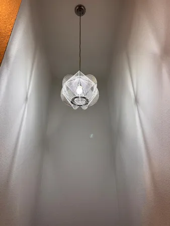 a view of a room with a chandelier fan