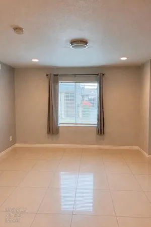 a view of an empty room with a window