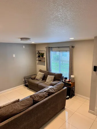 a bedroom with furniture and a window