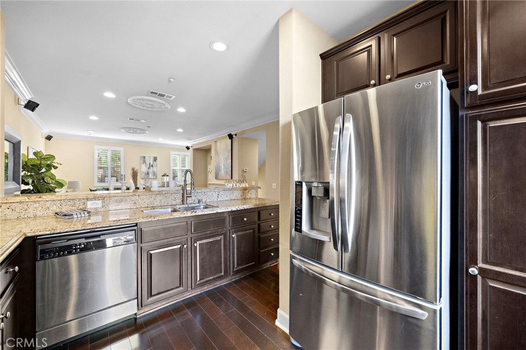 8028 Monaco Stanton, CA 90680 - Photo 4 of 35 stainless double sinks, and stainless appliances including a gas range, dishwasher, and microwave