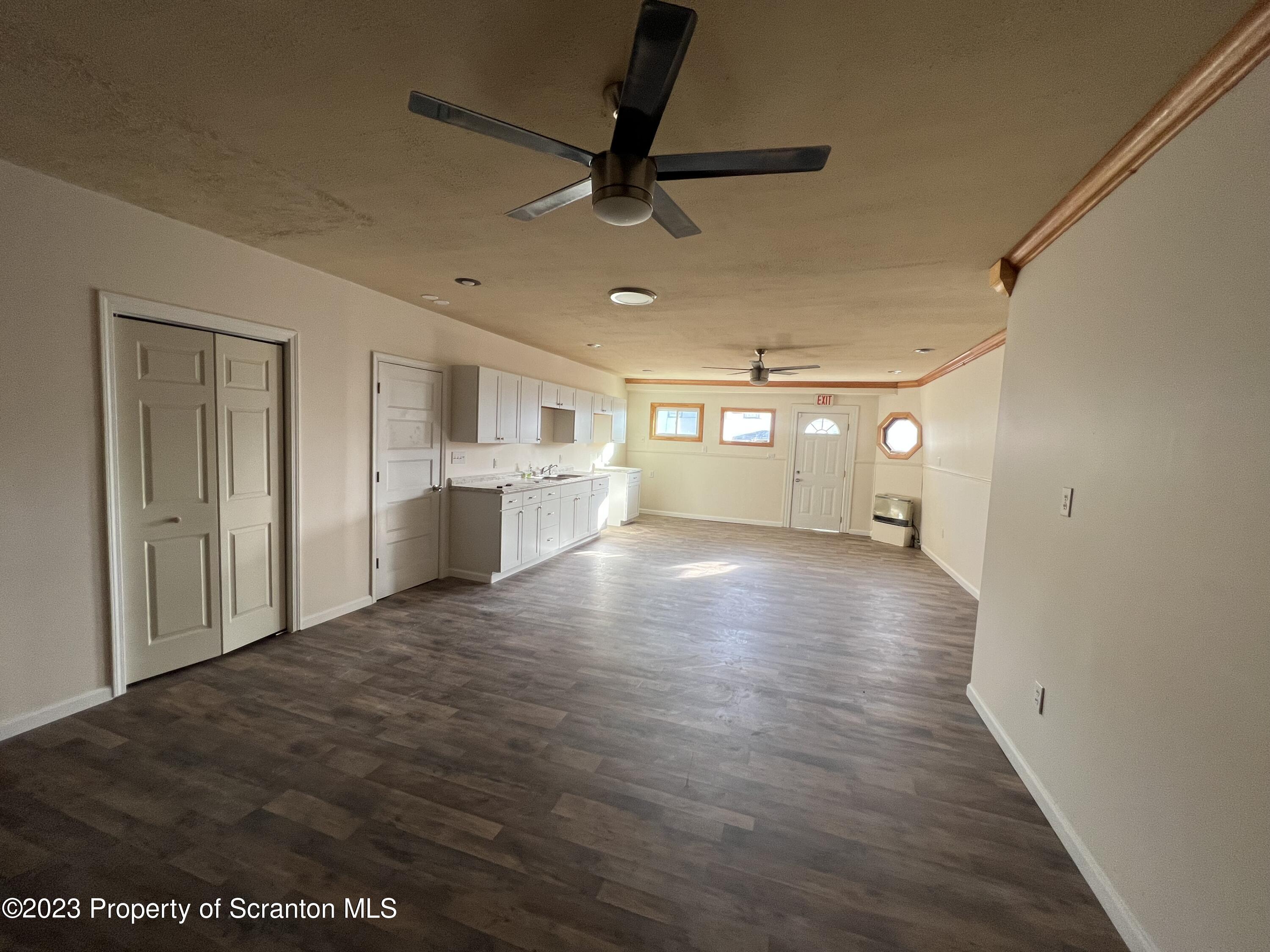 501 North Bromley Avenue Scranton, PA 18504 - Photo 3 of 17 a view of empty room with wooden floor and fan