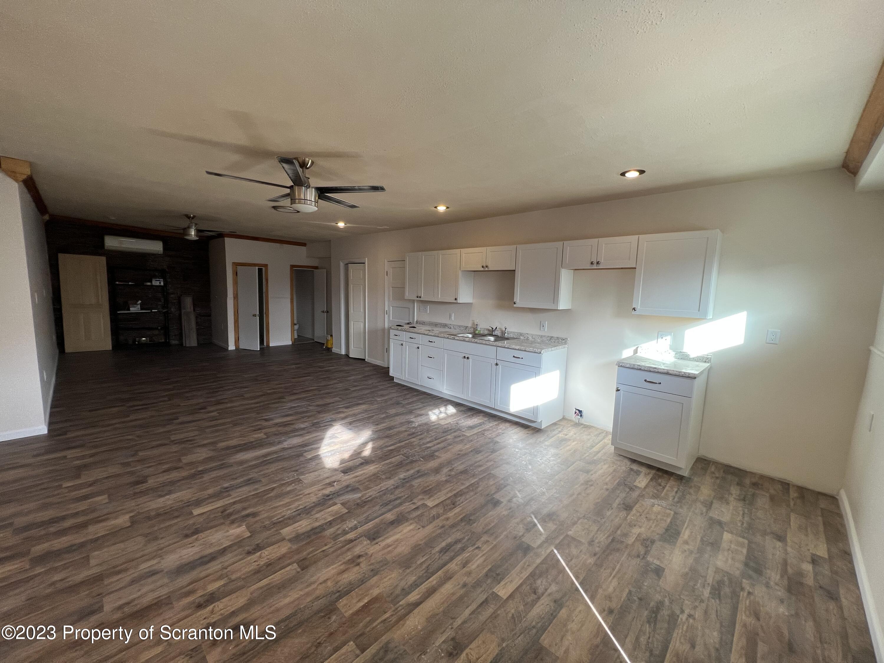501 North Bromley Avenue Scranton, PA 18504 - Photo 4 of 17 a view of a kitchen with kitchen island a sink stainless steel appliances and cabinets