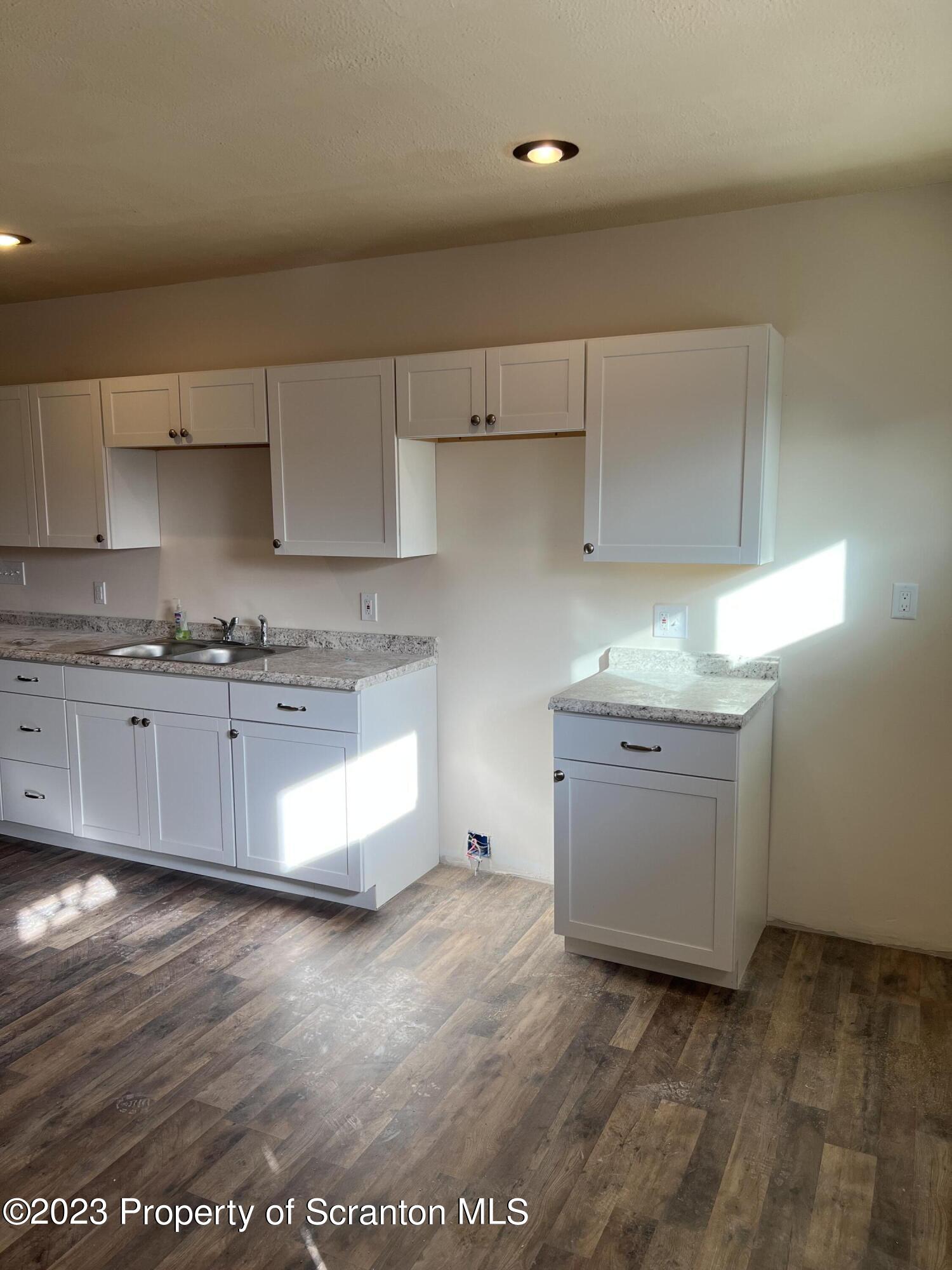 501 North Bromley Avenue Scranton, PA 18504 - Photo 6 of 17 a kitchen with granite countertop white cabinets and white stainless steel appliances