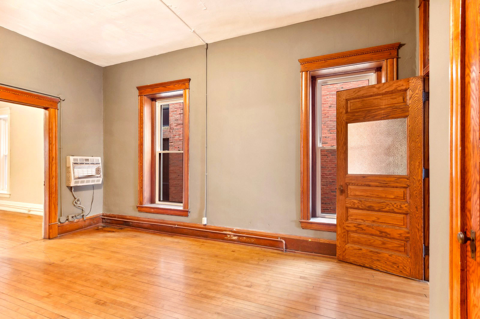 169 South Schuyler Avenue, Unit 34 Kankakee, IL 60901 - Photo 13 of 19 a view of an empty room with wooden floor and a window