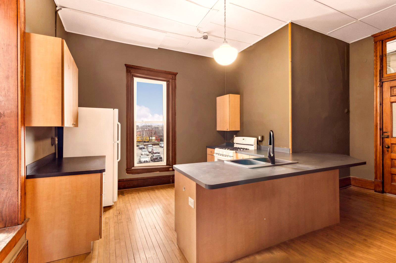 169 South Schuyler Avenue, Unit 34 Kankakee, IL 60901 - Photo 2 of 19 a kitchen that has a sink a window in it and a granite counter top
