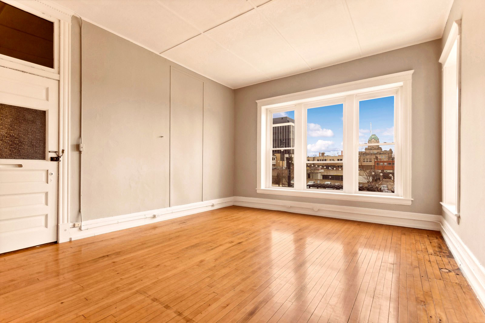 169 South Schuyler Avenue, Unit 34 Kankakee, IL 60901 - Photo 6 of 19 a view of an empty room with a window and wooden floor