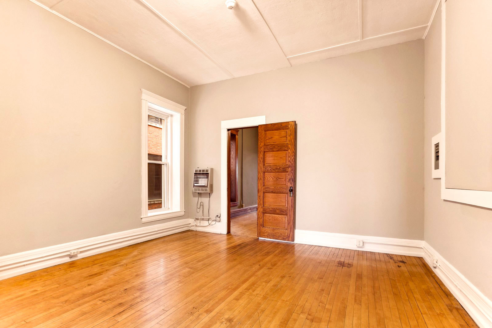 169 South Schuyler Avenue, Unit 34 Kankakee, IL 60901 - Photo 10 of 19 an empty room with wooden floor and windows