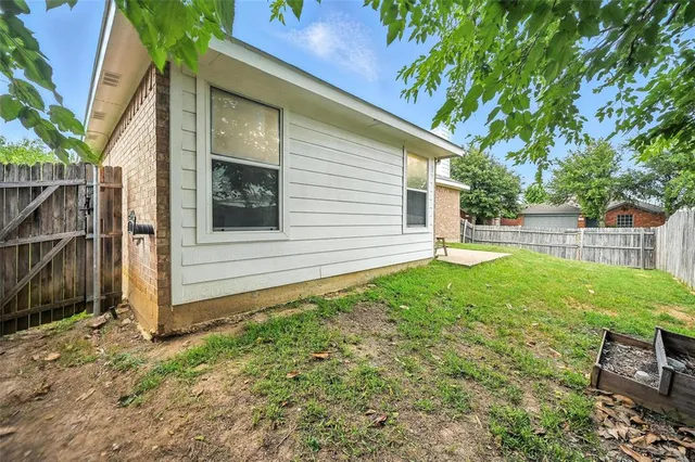 a view of a house with a yard and a garden